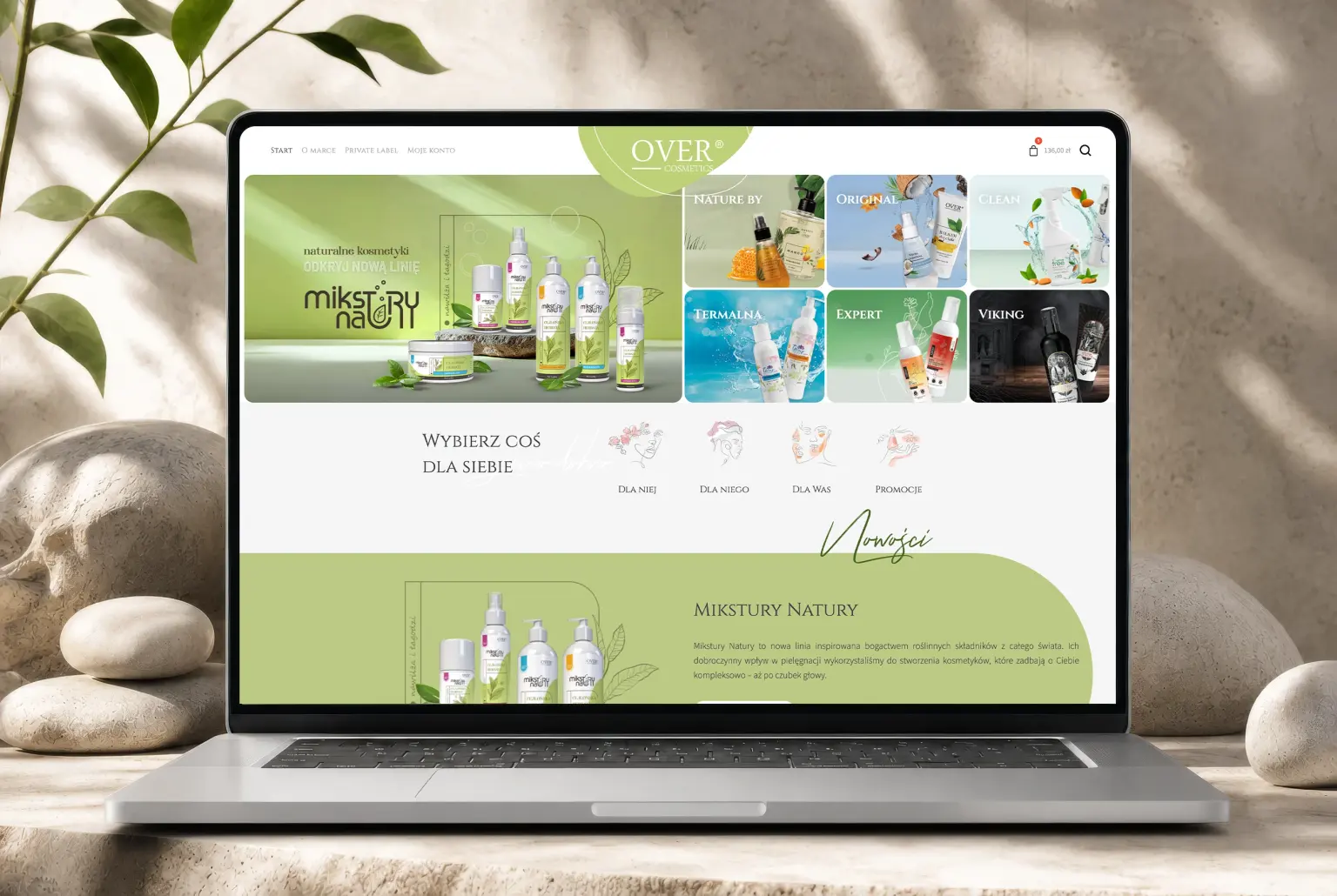 OVER Cosmetics — the store homepage on a laptop: product line tiles and the for her, for him, for you both selector