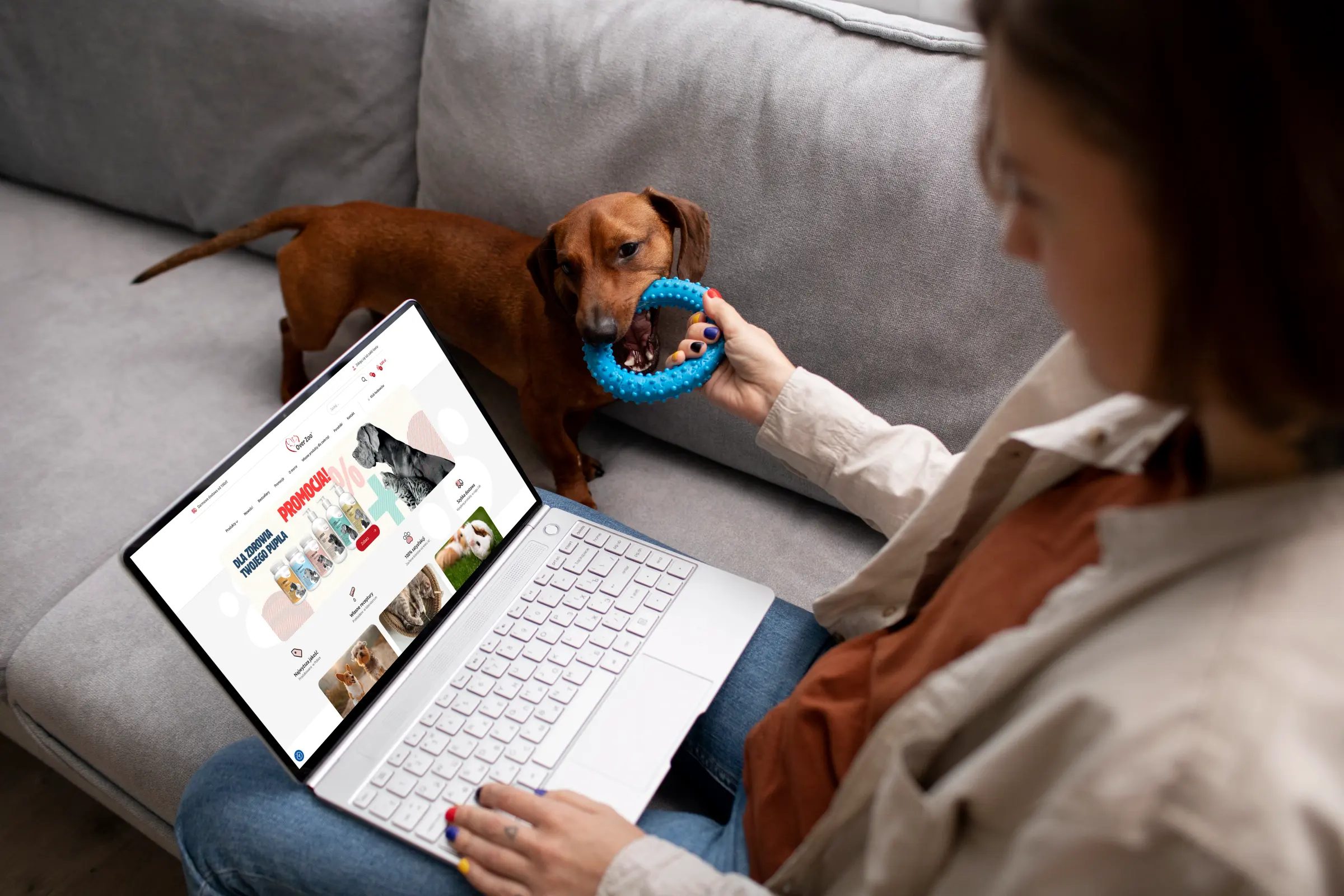 OVER Zoo — the online store on a laptop, a woman with her dog on the sofa